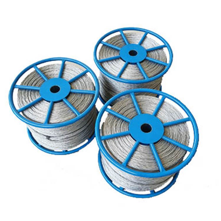 Blue-reeled spools of silver high-tensile wire, designed for excavator/heavy equipment use, showcasing durable construction for tough jobs.