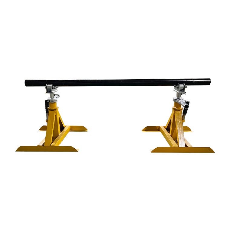 Yellow heavy-duty adjustable pipe roller stands holding a black pipe, ideal for industrial pipe support during installation.