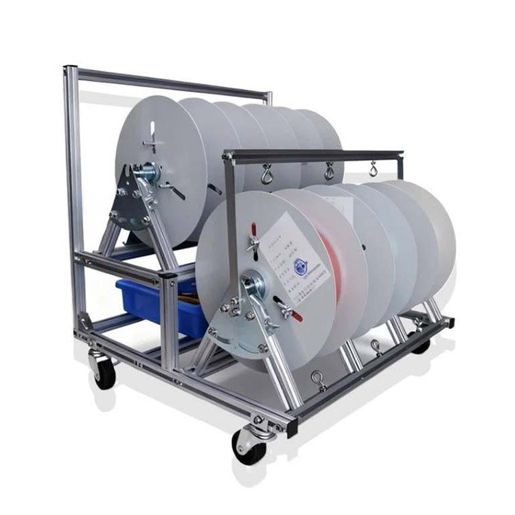 Industrial cable reel trolley with multiple white spools, sturdy metal frame, smooth-rolling wheels, and blue storage bin for organized cable management.