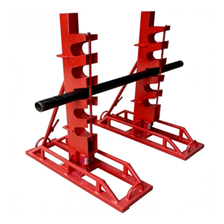 Red heavy-duty pipe support stand holding a black pipe, industrial equipment for secure pipe storage and handling in construction
