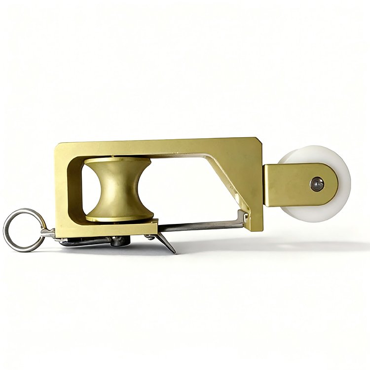 Gold excavator rigging pulley with white wheel, metal ring, and sturdy build for heavy lifting