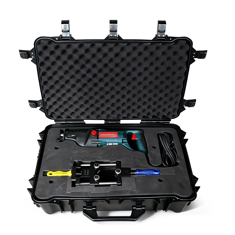 Black rugged carrying case with foam inserts holding a hydraulic power tool, a hydraulic unit, and cables for industrial use.
